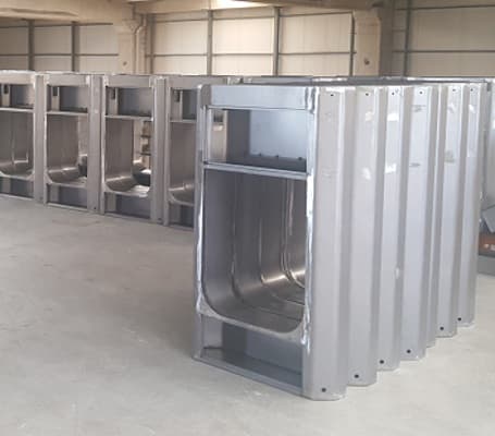 Formed stainless steel kiosk housing shells lined up in a workshop