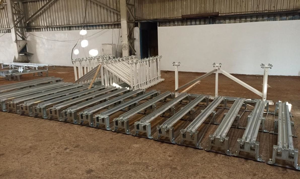 Galvanized steel roller conveyor frames and rail assemblies laid out in a warehouse