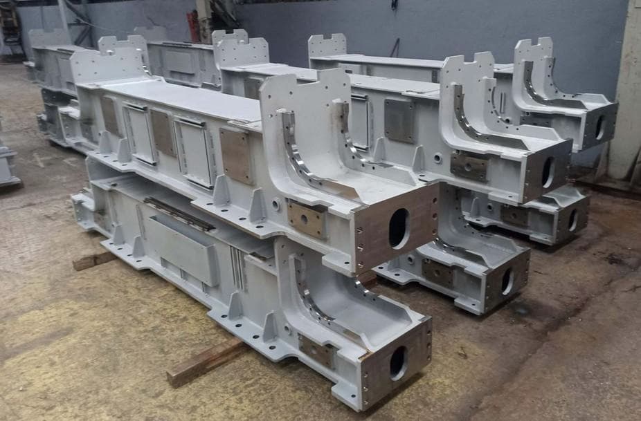 Large precision-machined steel machine bed components ready for assembly