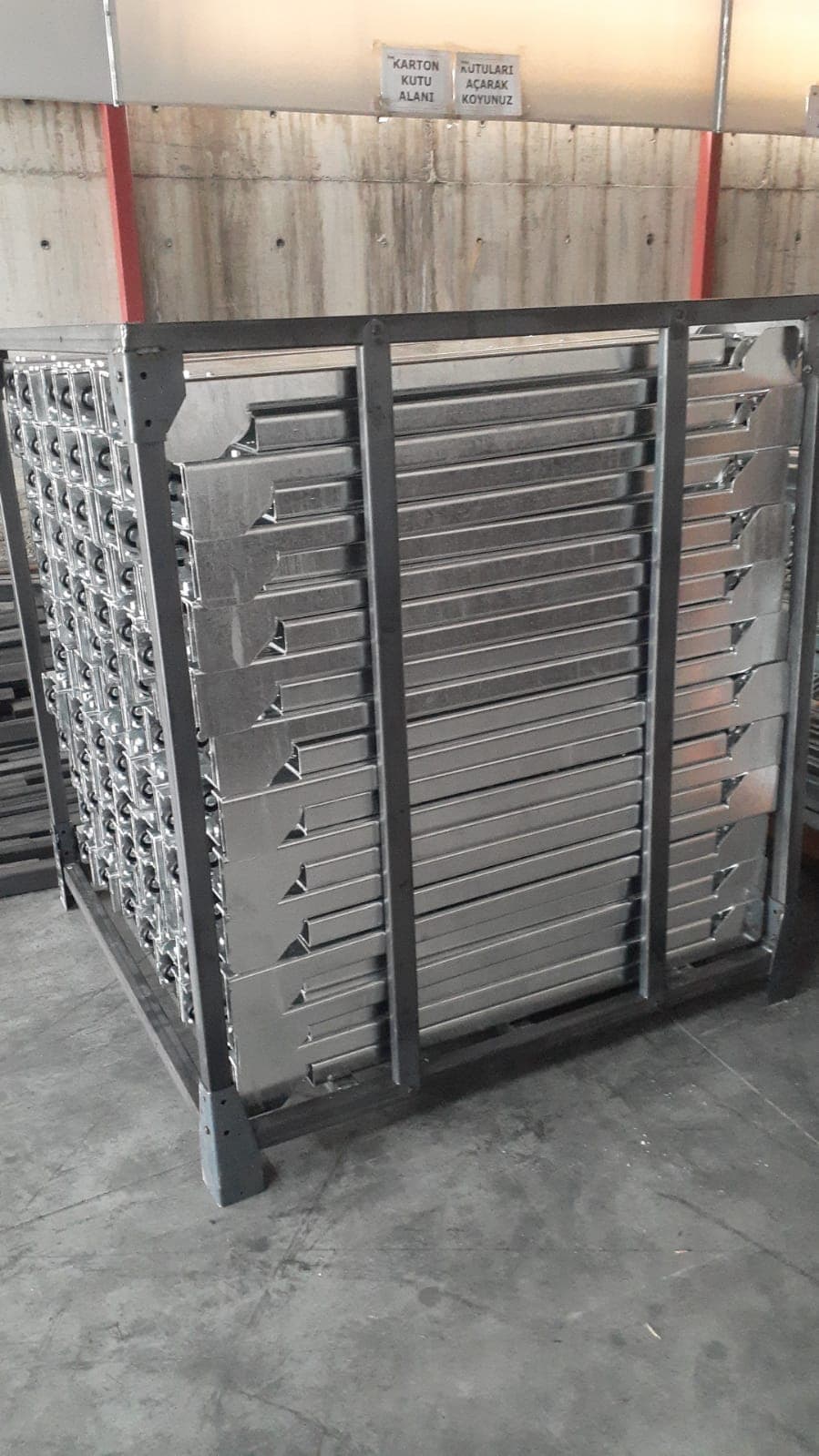 Stacked galvanized steel channel parts secured in a shipping crate