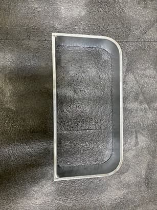 Curved formed sheet metal panel component with a rounded edge