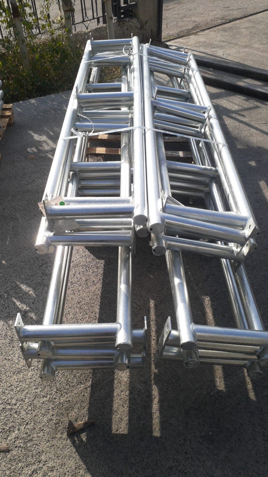 Stacked bundles of galvanized tubular steel frame components ready for shipment